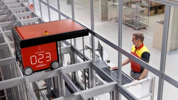 person operating robot on asrs system